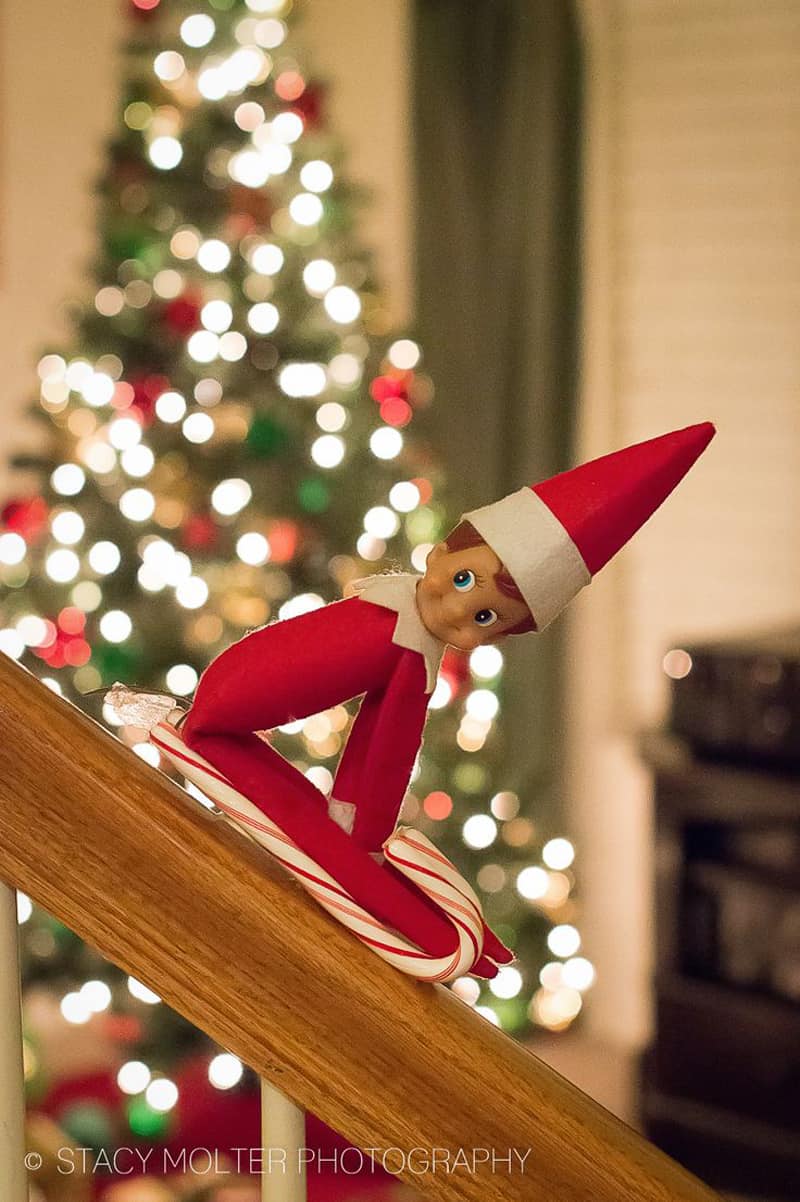 Elf sliding down the newel using a candy stick