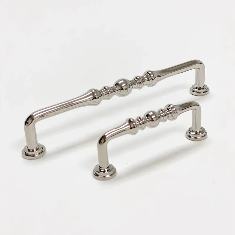 These polished nickel kitchen cabinet pulls, with their distinct beaded and fluted textures, offer a refined hardware accent for elegant interior design.