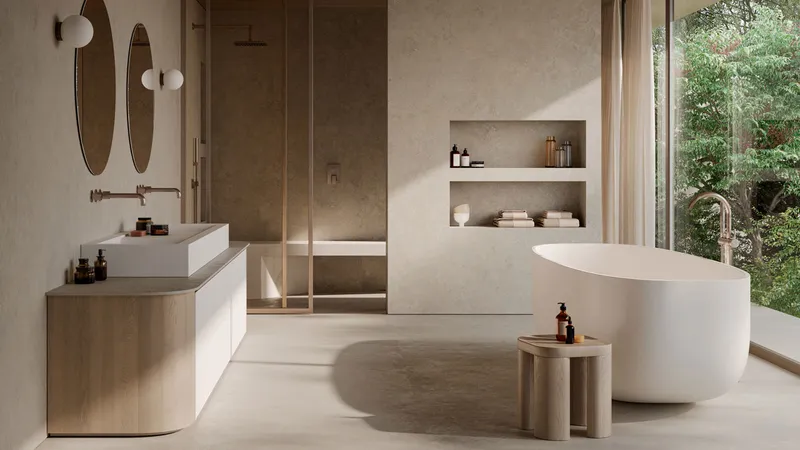 A tranquil contemporary bathroom features a sculptural white ceramic bathtub, a floating oak vanity with an integrated sink, and textured concrete walls in an open-plan design.