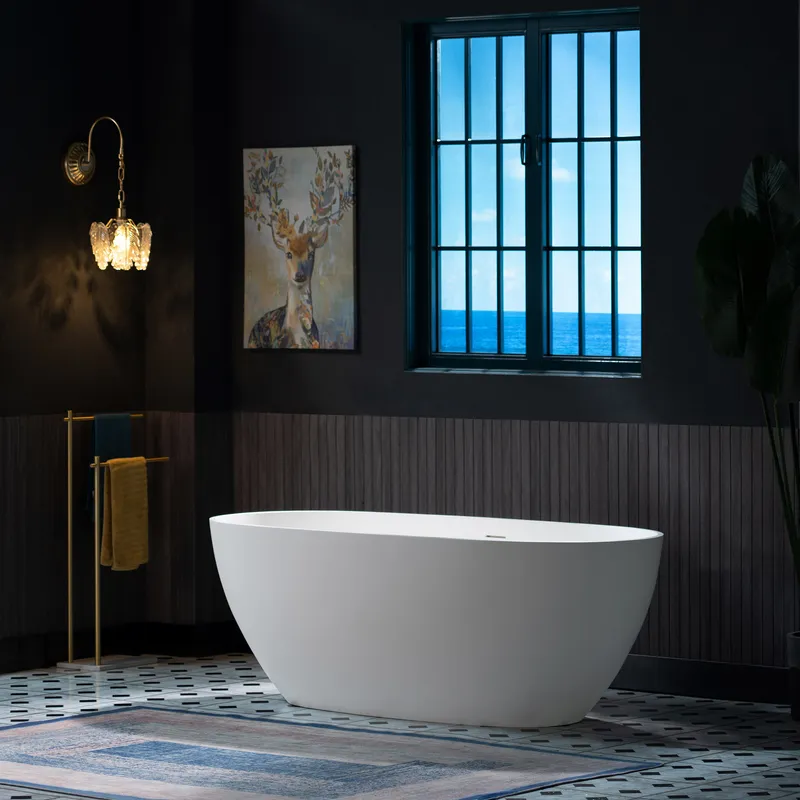 A minimalist white freestanding bathtub anchors this luxurious bathroom design, featuring dark paneled walls, a vibrant patterned rug, and an ocean view.